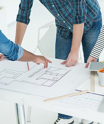 group of designers consulting over building plans