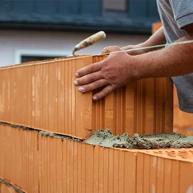 bricklayer building a wall